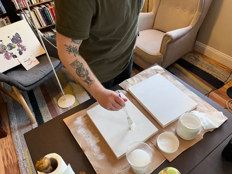 Matty applying gesso to art panels